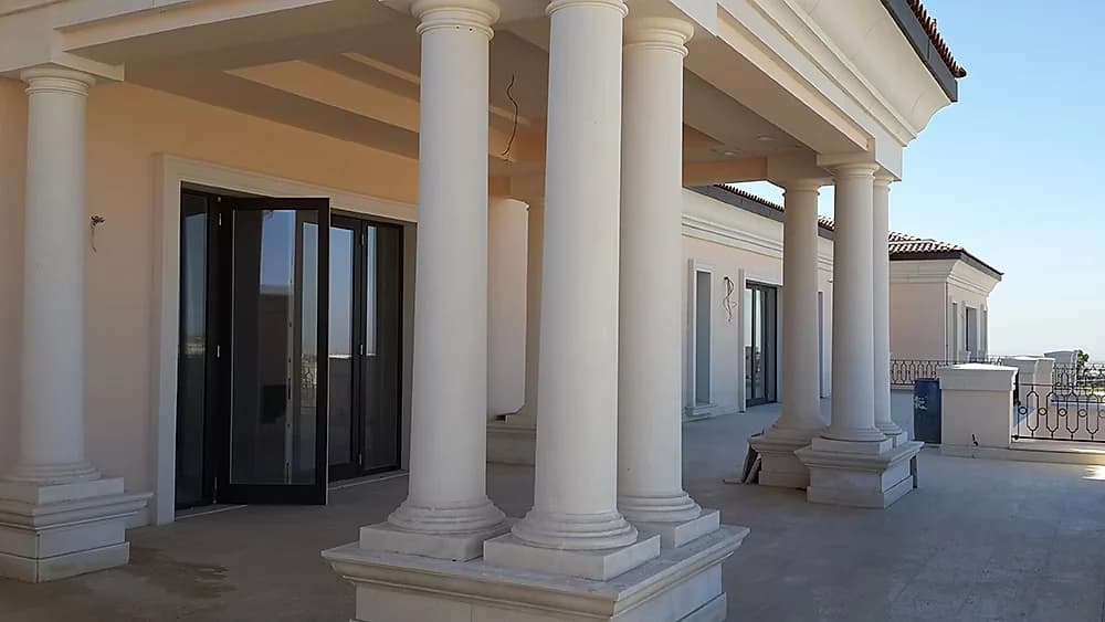 Colonnaded terrace along the garden elevation, with glazed doors between the columns