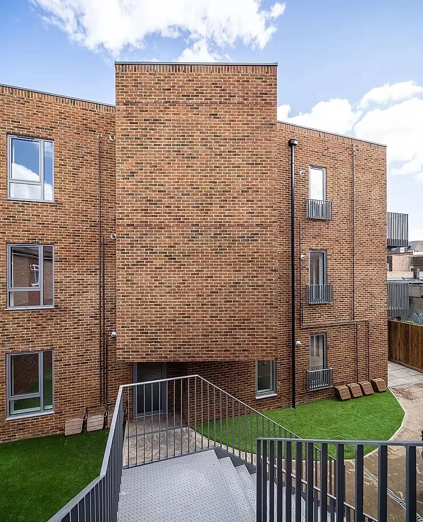 Rear elevation with the stair down to the lower courtyard and artificial lawn