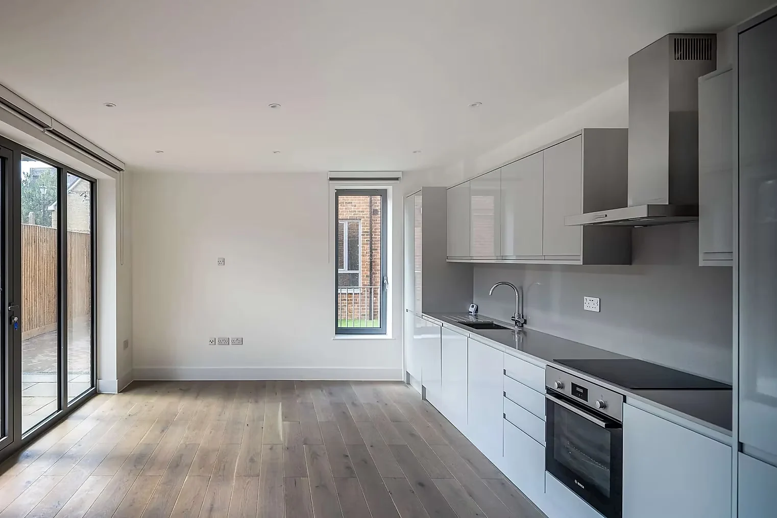 Kitchen and living room with full-height glazing onto the courtyard