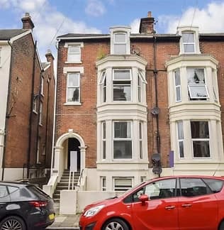 Red-brick Victorian bay-fronted terrace on a Portsmouth street